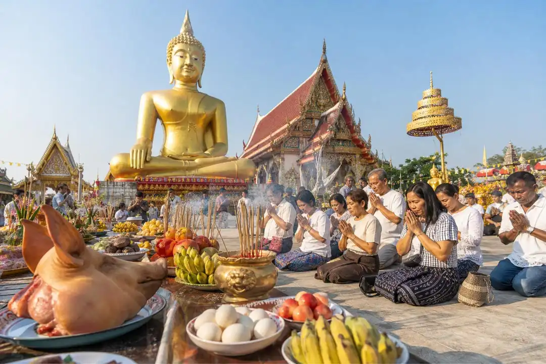 ภาพพิธีแก้บนหลวงพ่อสมหวัง หน้าวิหารวัดในไทย มีองค์พระใหญ่สีทอง ผู้คนร่วมพิธี พร้อมหัวหมู ไข่ต้ม ผลไม้ และธูป เลขเด็ดงวดนี้ 167